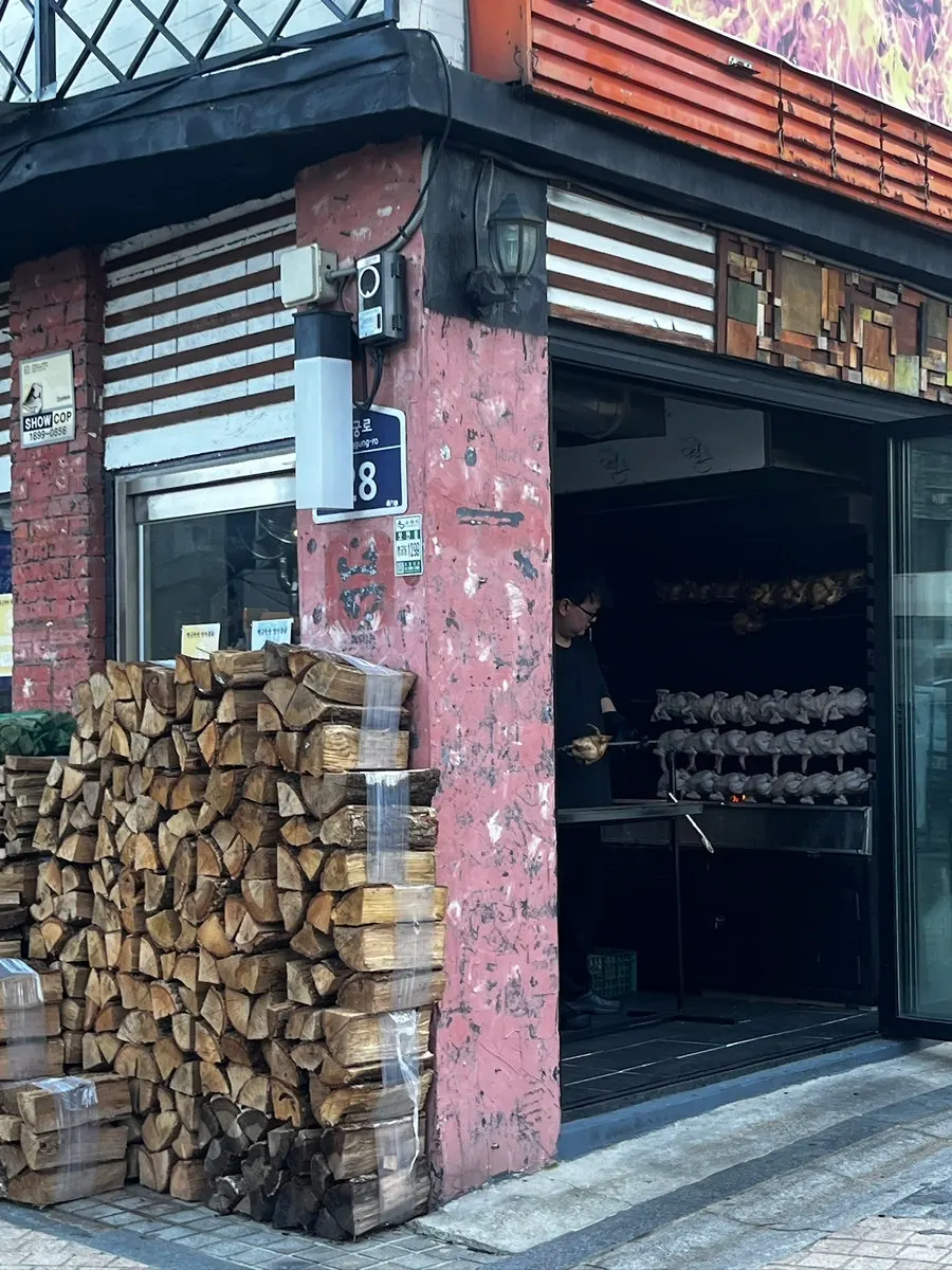 Stacked oak firewood in front of the restaurant