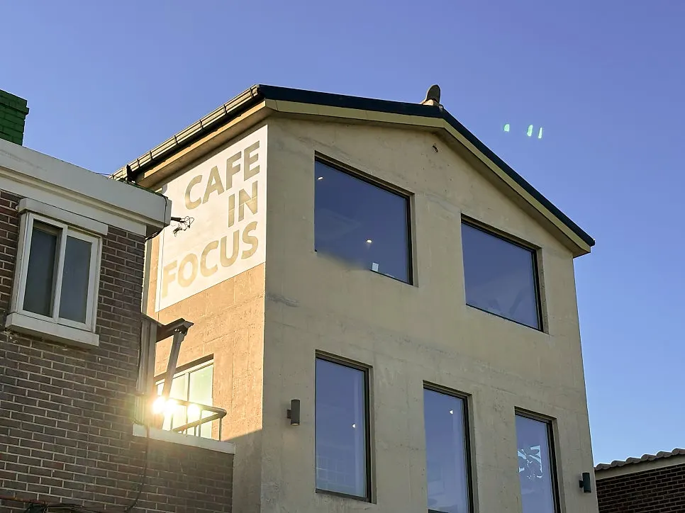 View of the Hwaseong Fortress wall path in front of Caffeine Focus