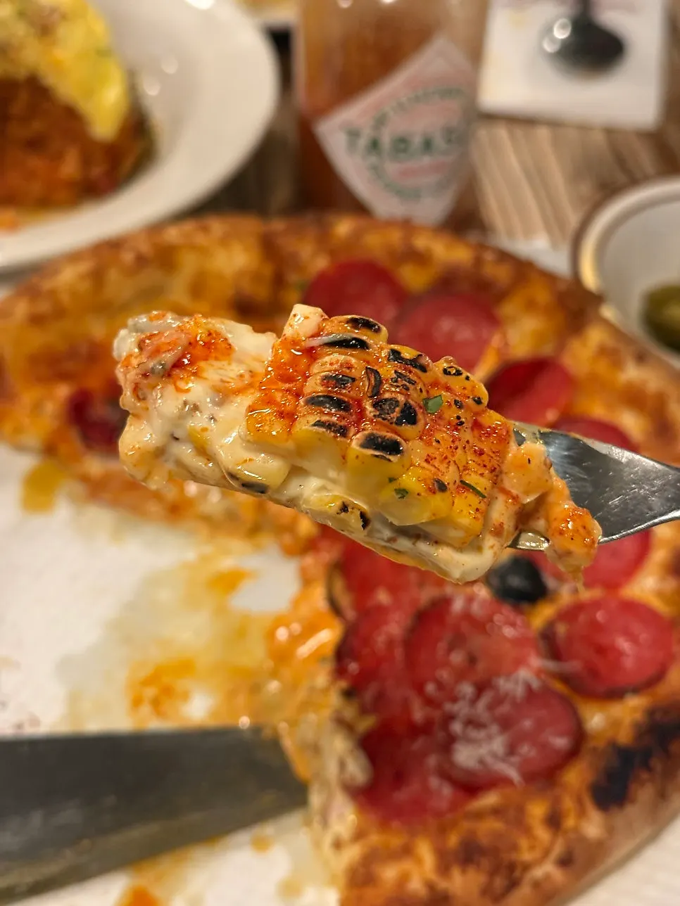 Cross-section of the corn pizza showing chewy dough