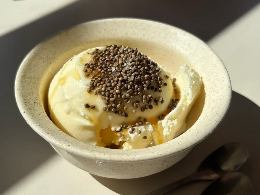 Vanilla ice cream topped with whole perilla seeds