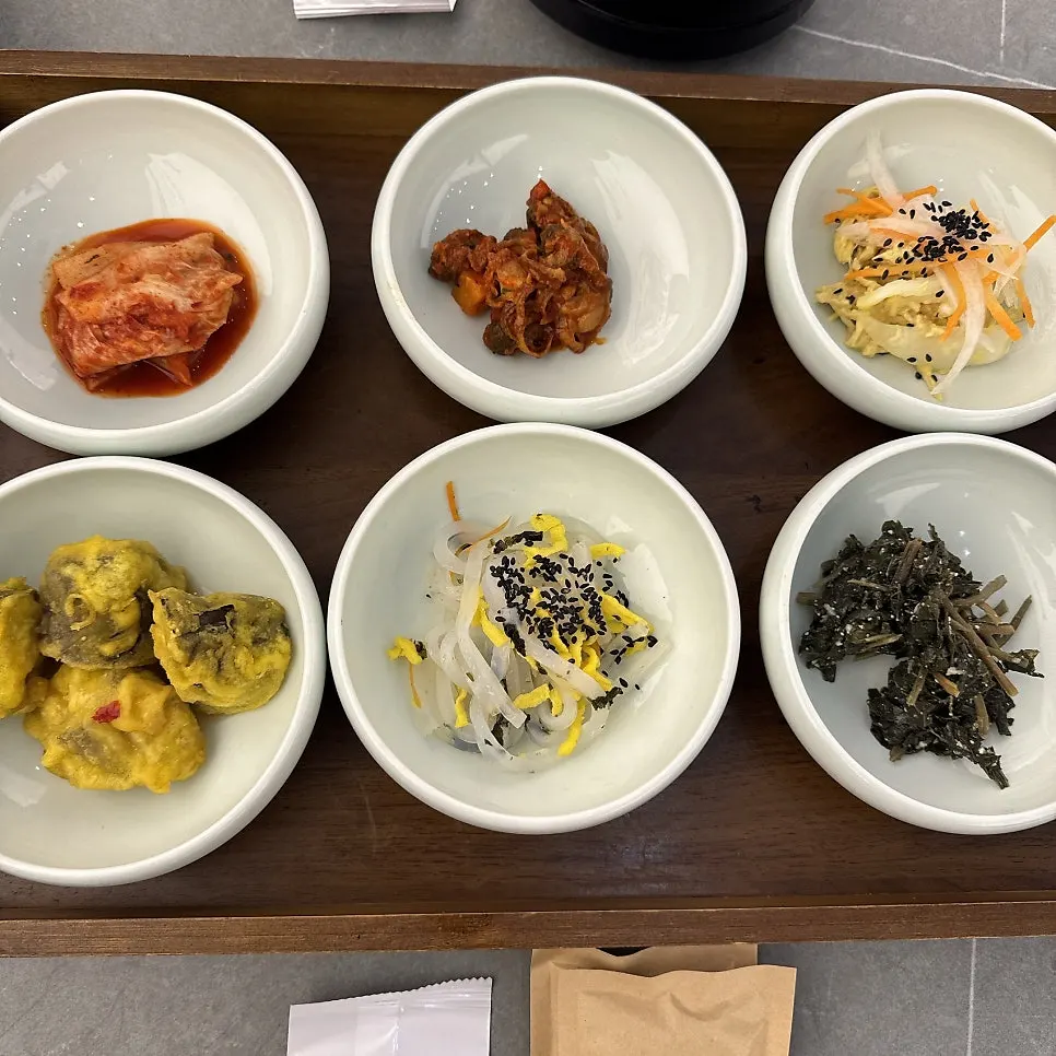 A neatly arranged spread of basic banchan