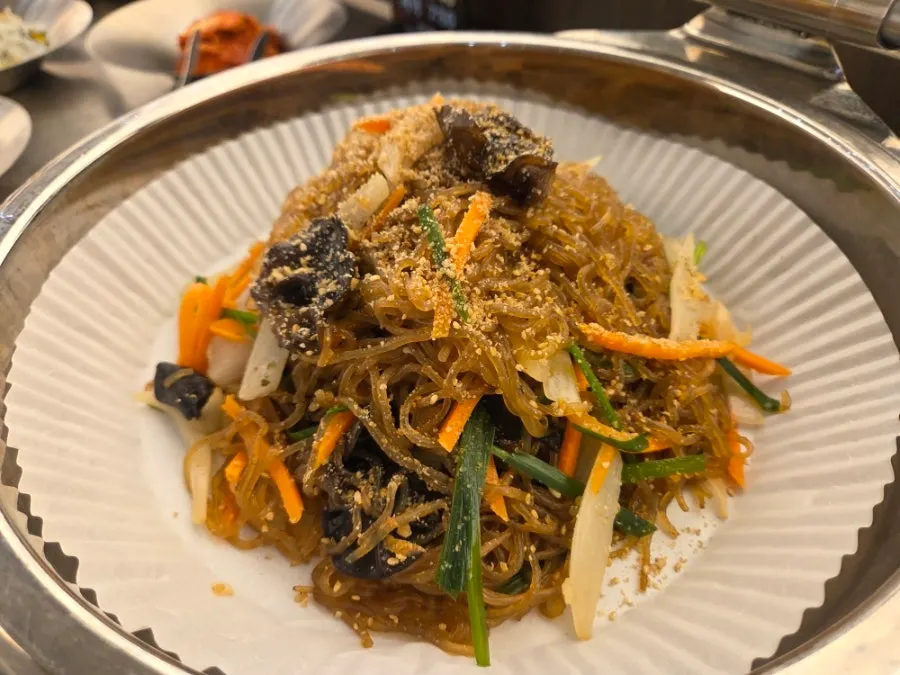 Neatly arranged banchan including cheongpomuk on the self-serve bar