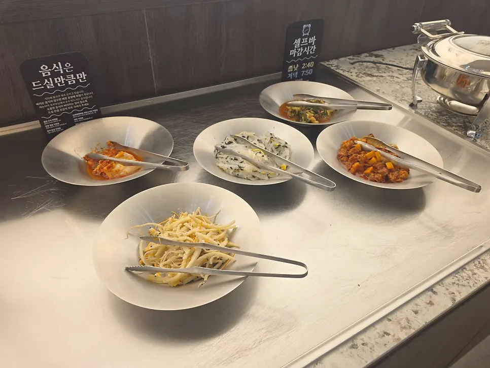 Plate of japchae and side dishes from the self-serve bar