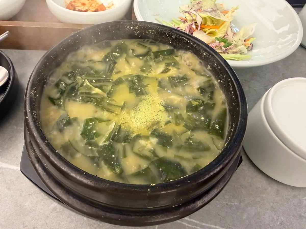 A full spread of neat side dishes and seaweed soups