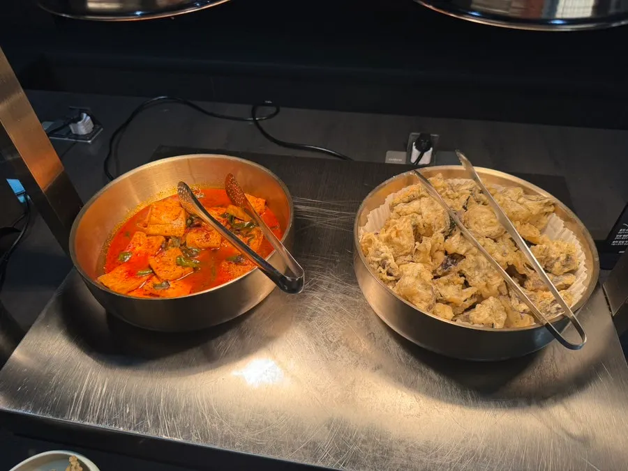 Self-serve bar with braised tofu and garlic scapes