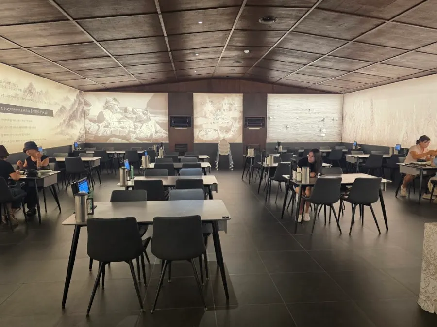 Hall with a folding-screen-style wall and bright lighting