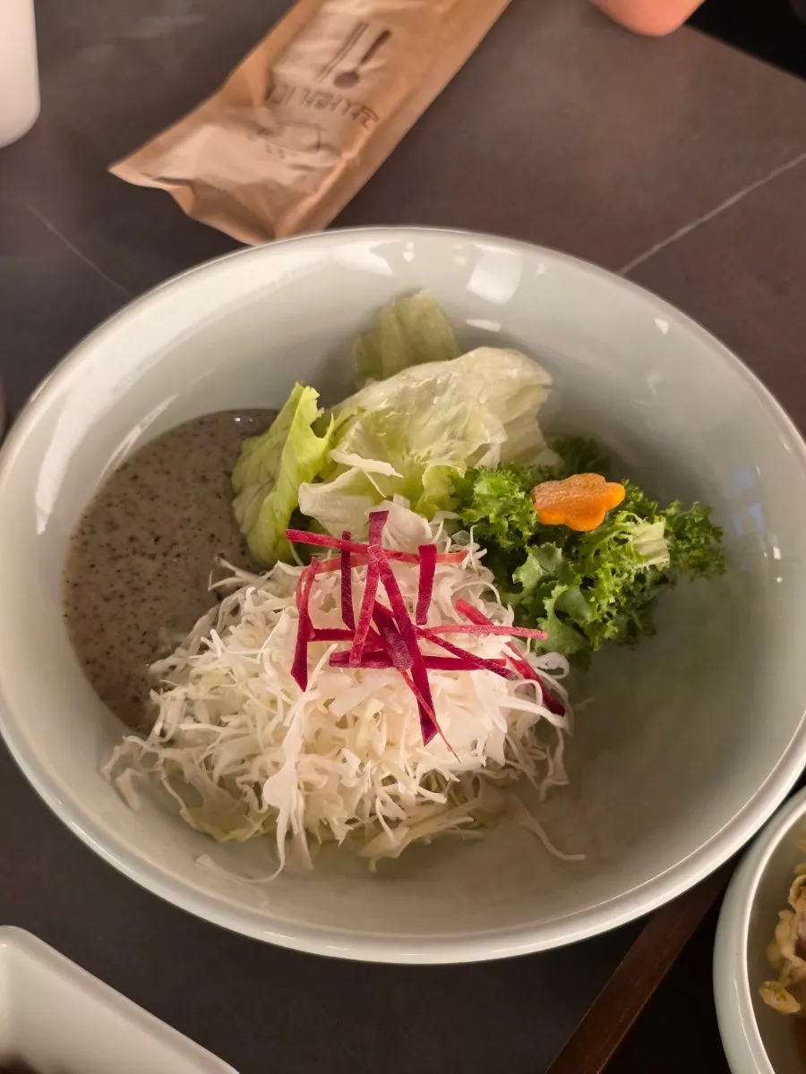 Generous salad topped with black sesame dressing