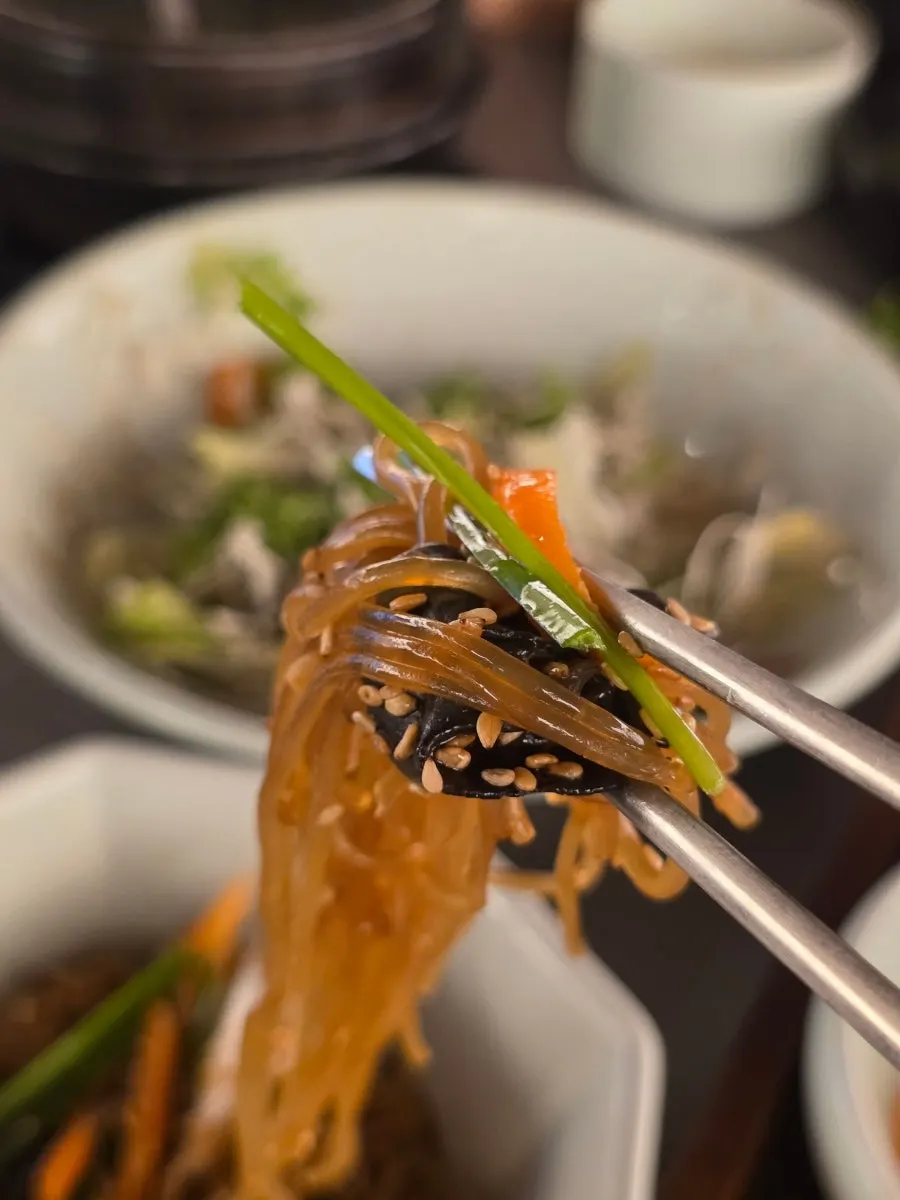 Seasoned grilled flounder served with japchae