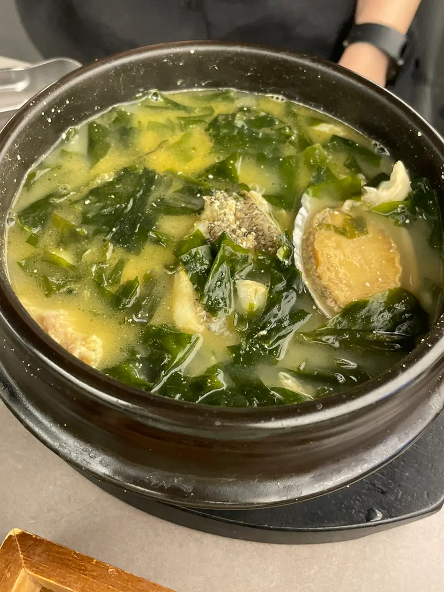 Earthenware pot of beef seaweed soup loaded with beef