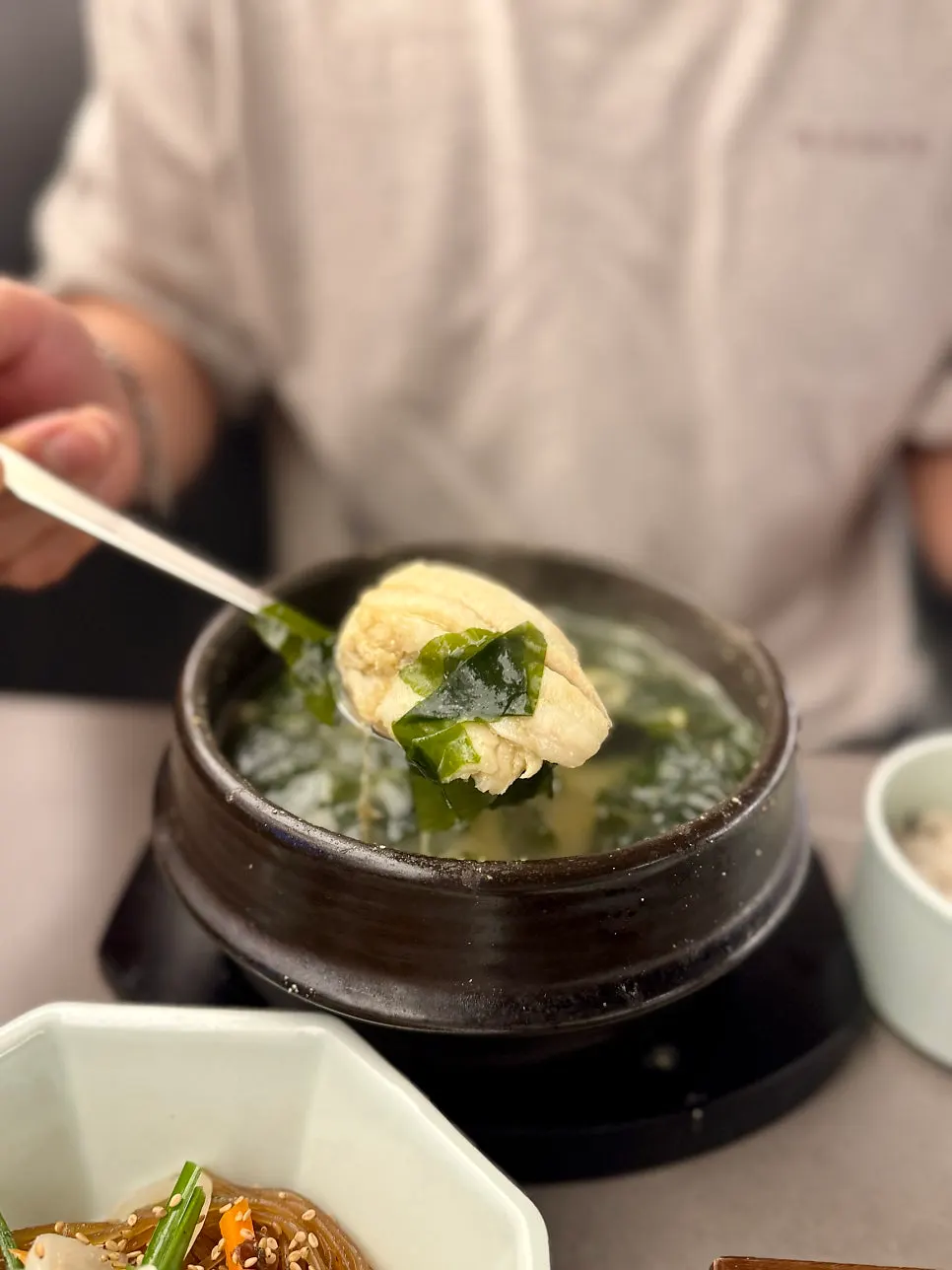 Picking apart the boneless flounder in the seaweed soup