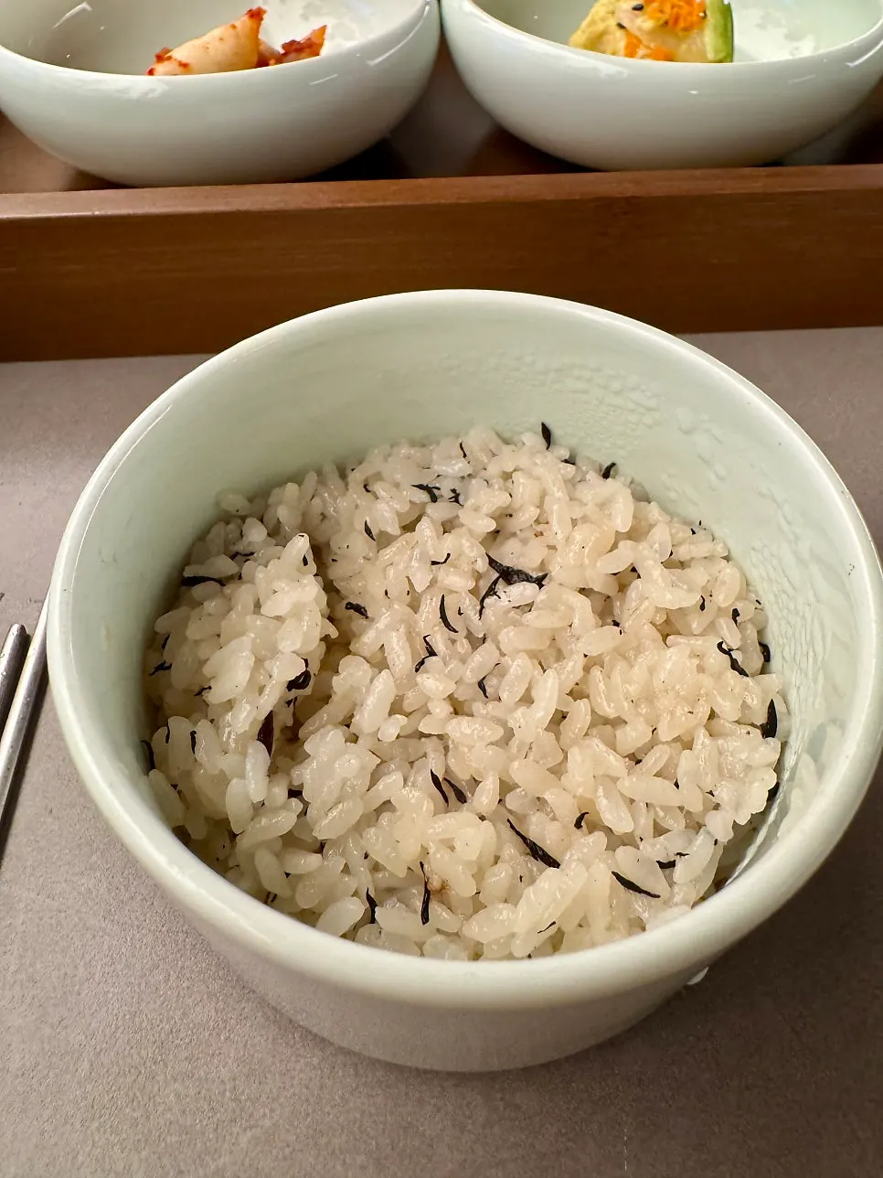 Sign for unlimited rice refills next to a rice bowl
