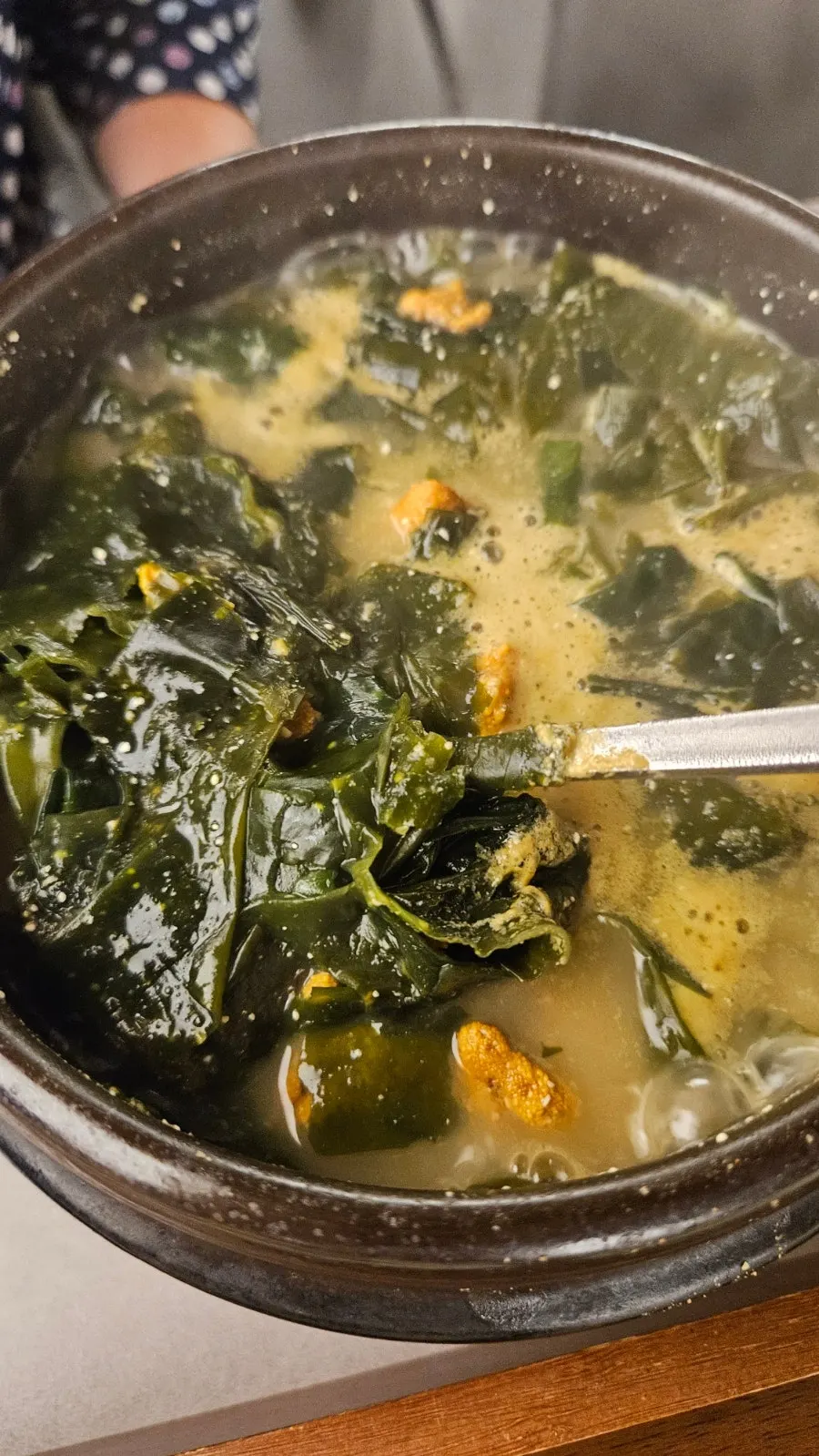 Stone bowl of sea urchin seaweed soup packed with sea urchin roe