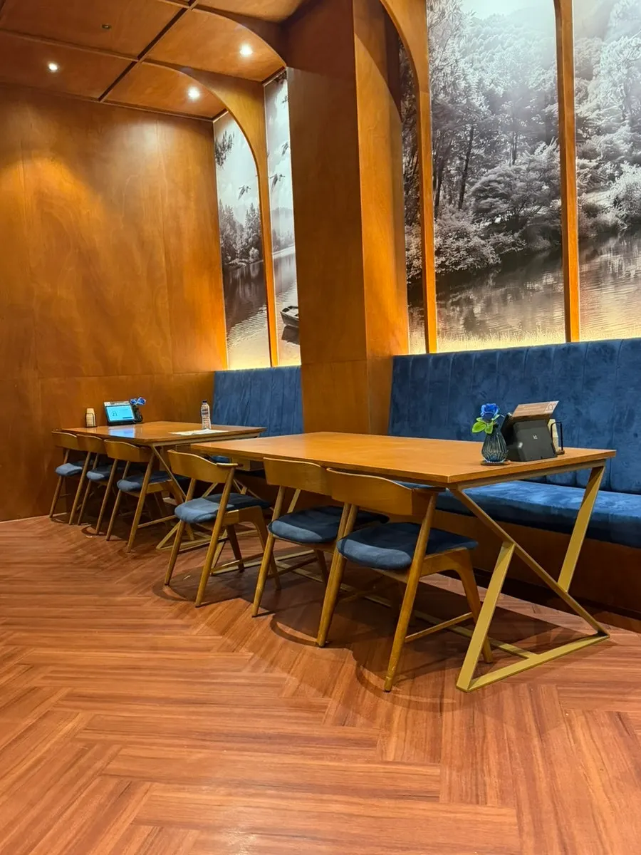 Two people seated at a large table at Haenyeo Sotbap