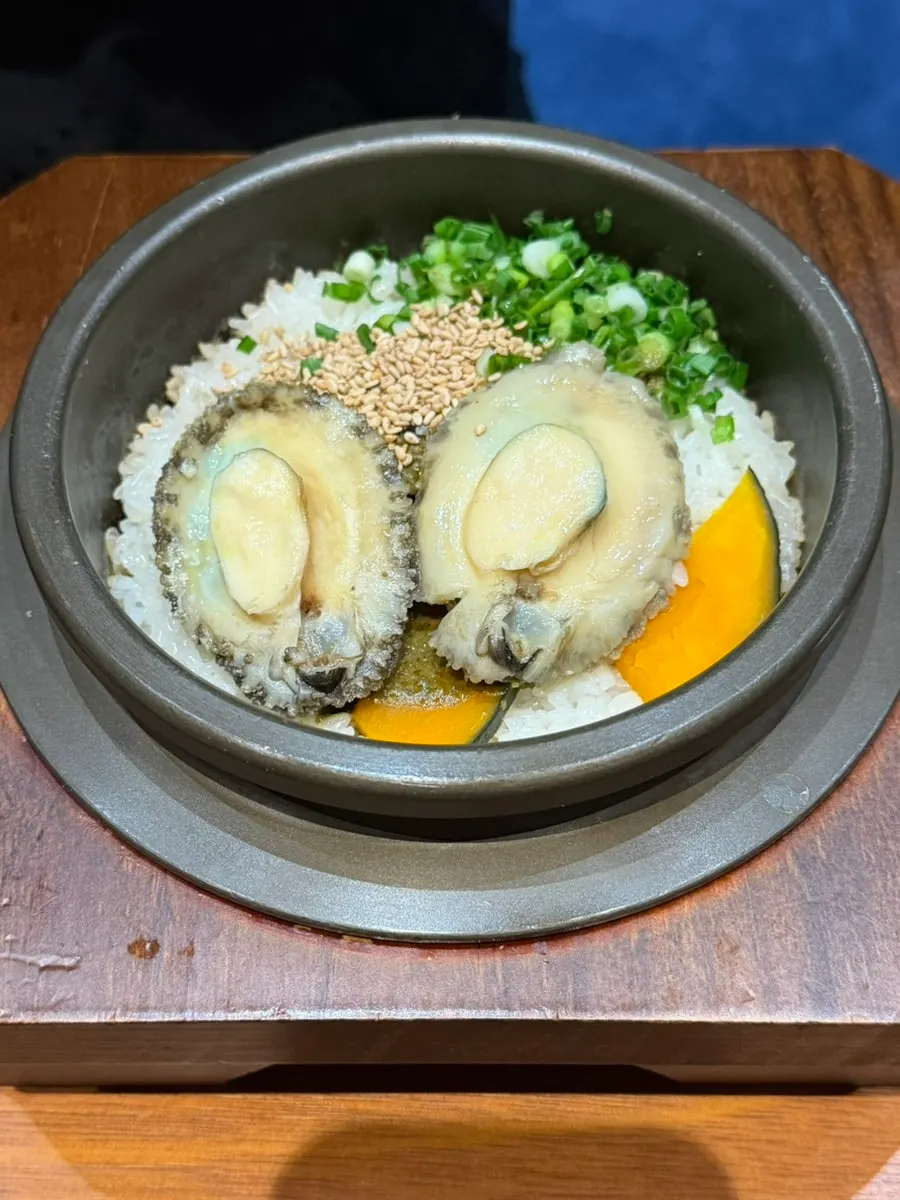 Mixed abalone sotbap served into a bowl with seaweed soup