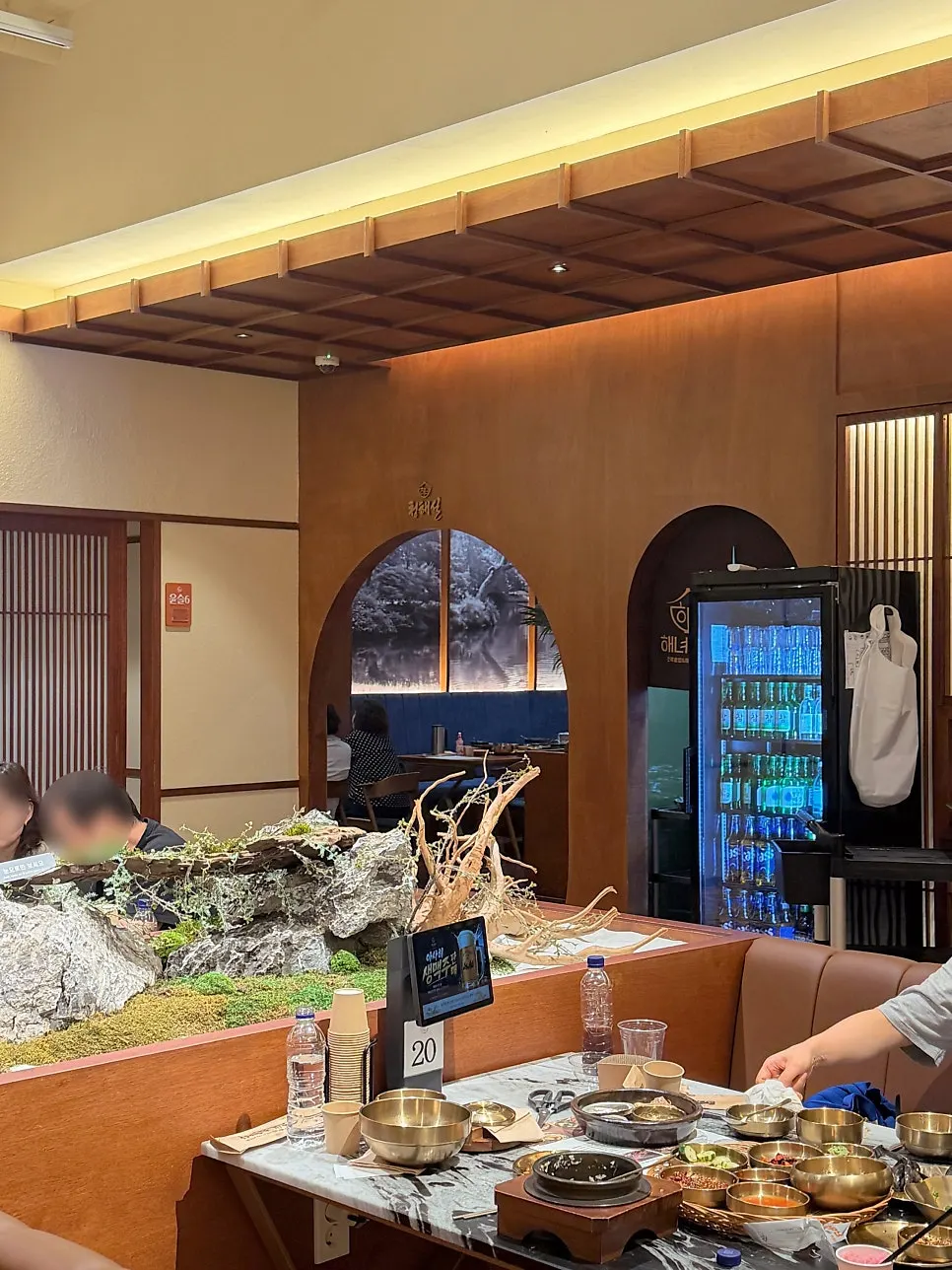 Haenyeo Sotbap interior with wood tones and lighting