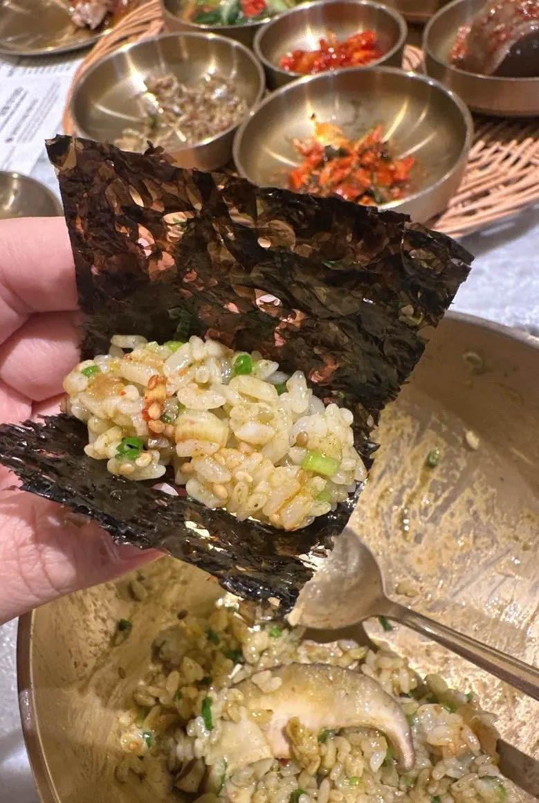 A bite of sotbap wrapped in gim