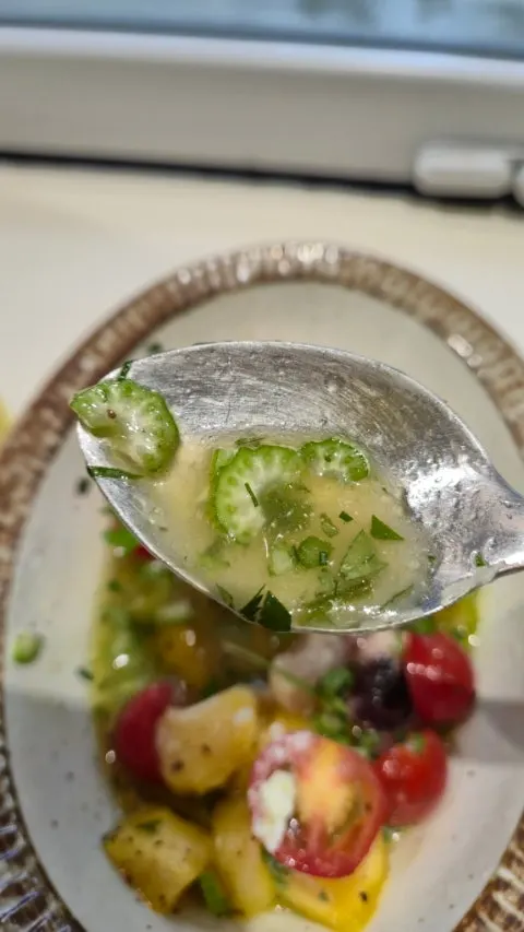 Close-up of the salad showing round, thinly sliced vegetables