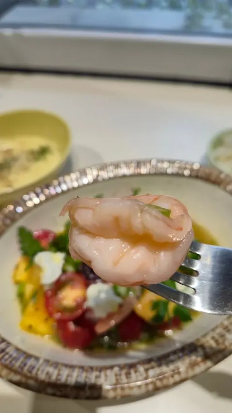 A spoonful of mashed potatoes being lifted