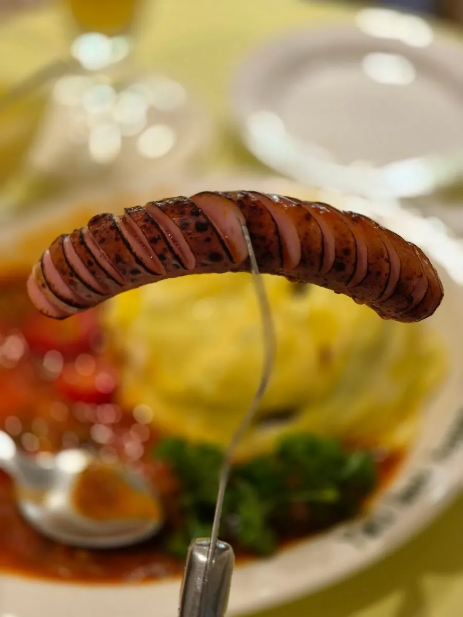 Close-up of omurice topped with tomato-based sauce