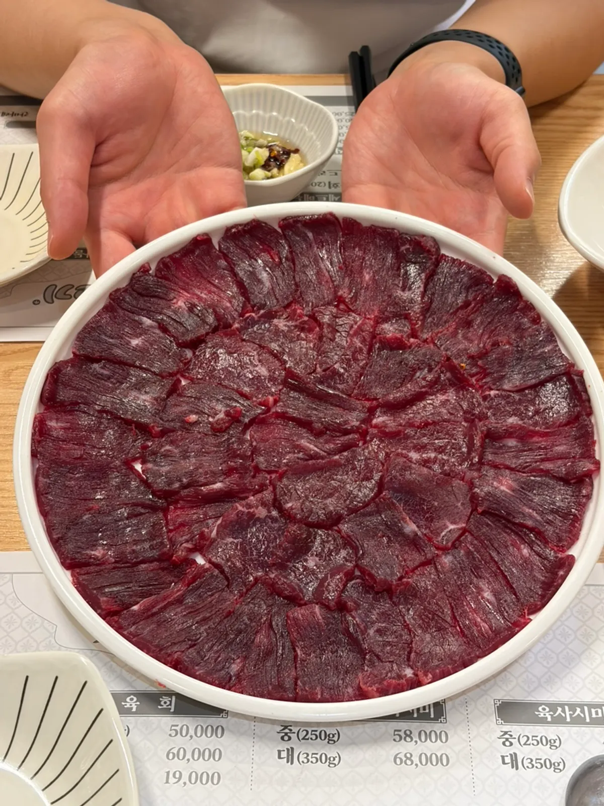 Raw beef table setting at Haepumsosaeng Gogi