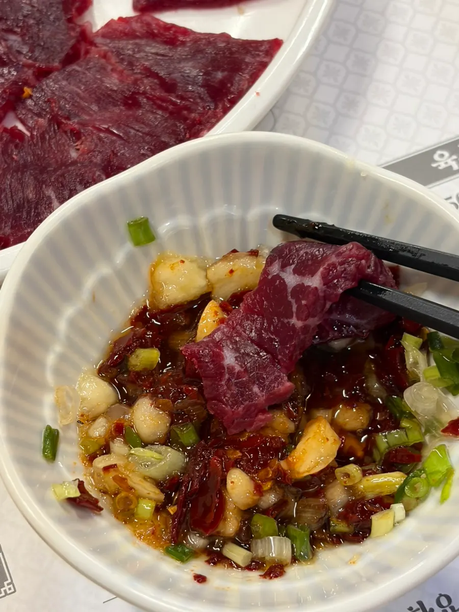 Raw beef dipping sauce with thickly cut garlic