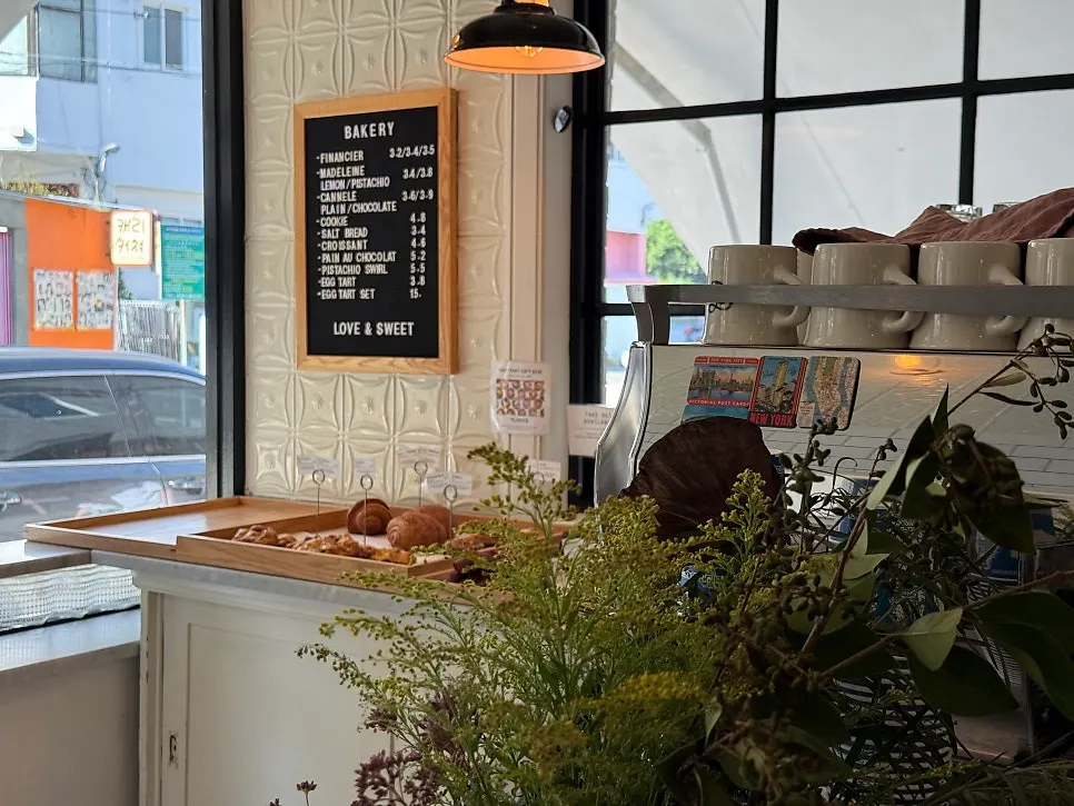 Café interior with window-side plants and vintage furniture