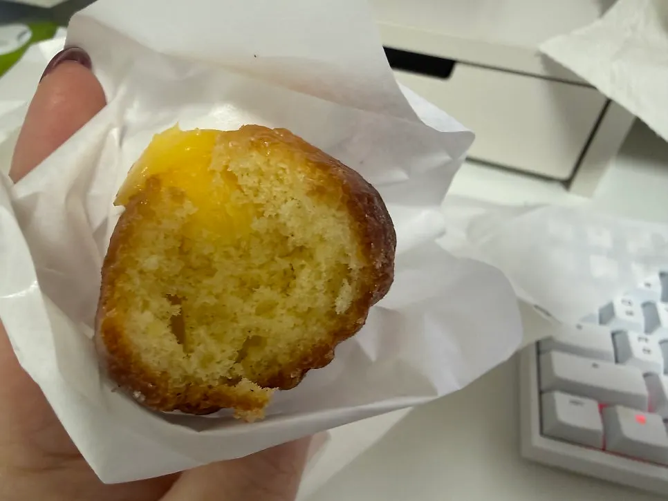 Cross-section of a lemon madeleine topped with lemon cream