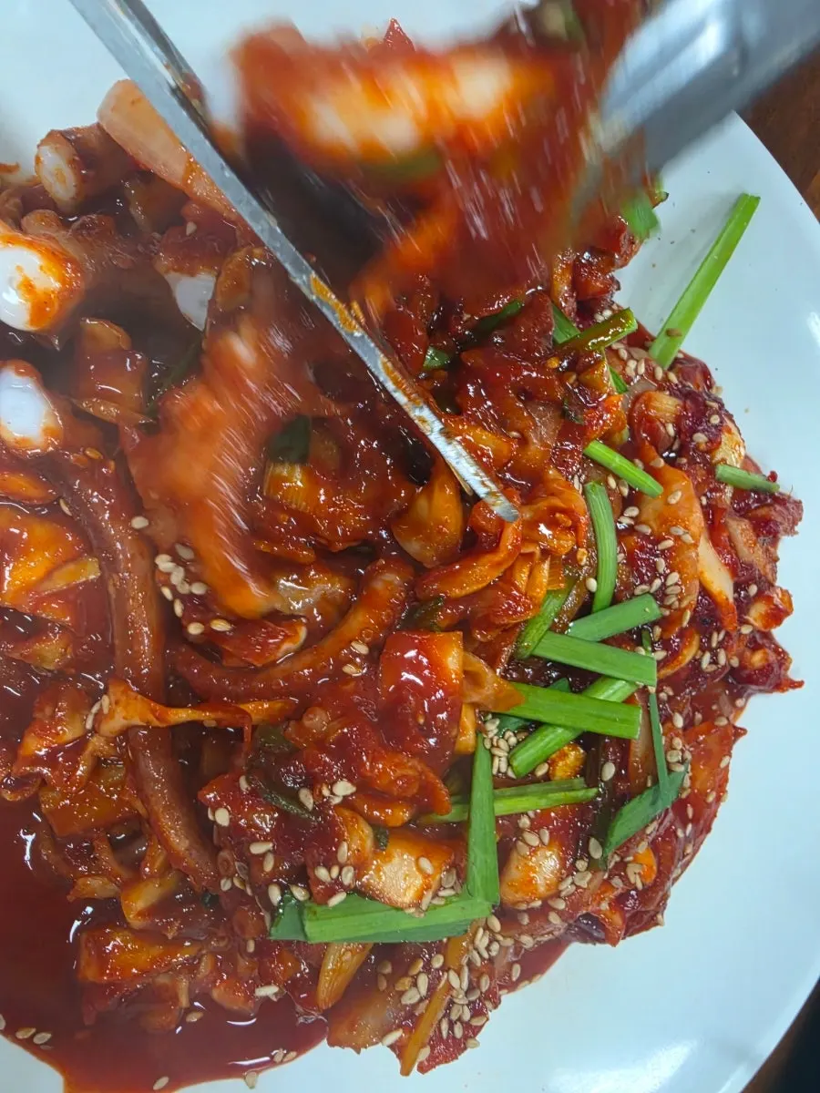 Springy octopus lifted with chopsticks