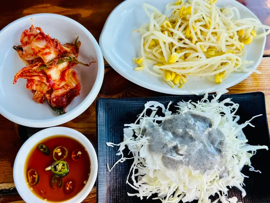 Basic side dishes of kimchi, bean sprouts, and cabbage salad