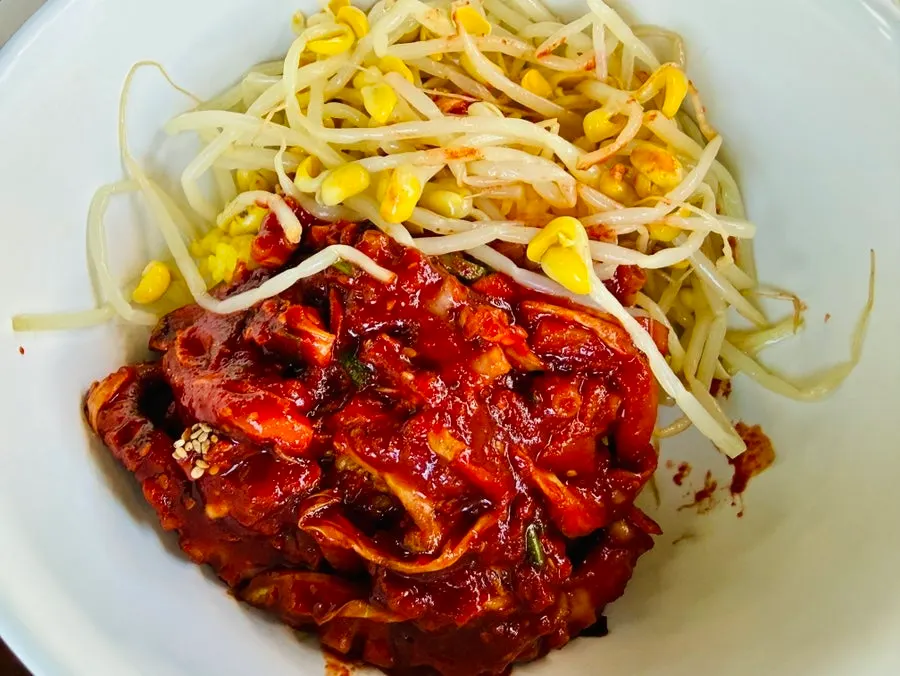 Turmeric rice mixed with octopus stir-fry and bean sprouts