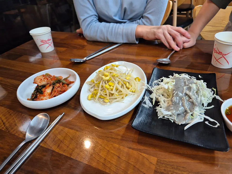 Basic side dishes of bean sprouts, kimchi, and salad