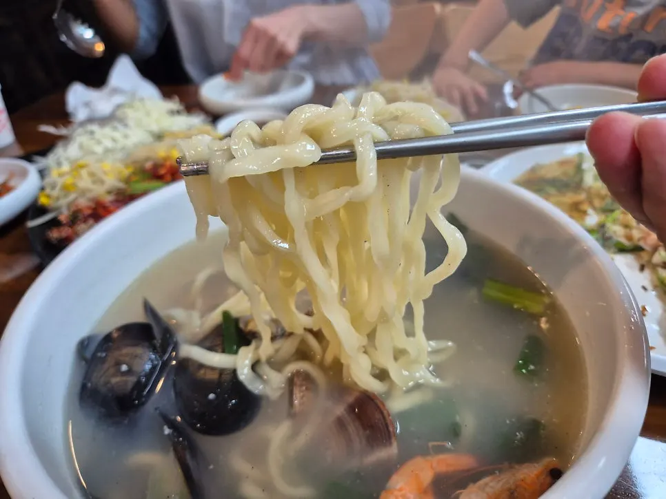 Broth and chewy noodles in the seafood kalguksu