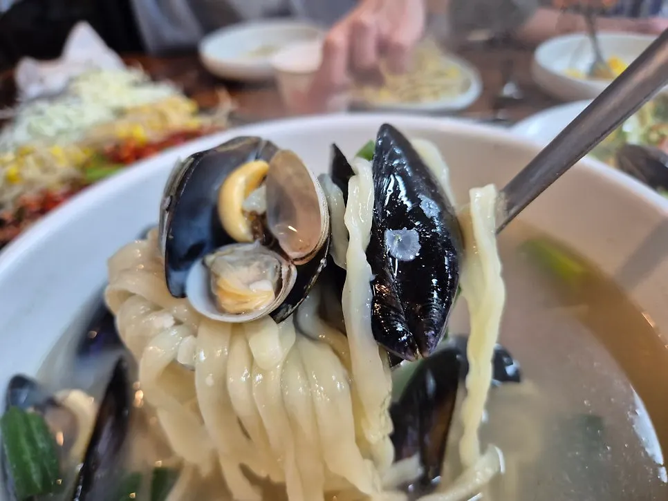 Table set with both octopus stir-fry and seafood kalguksu