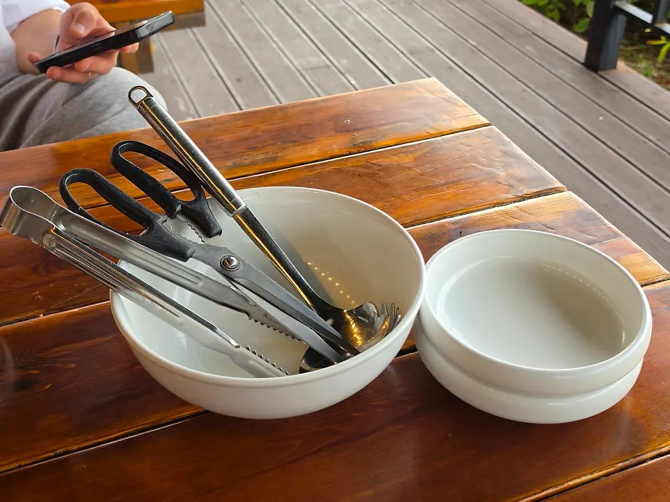 Table setting with small plates, tongs, and scissors