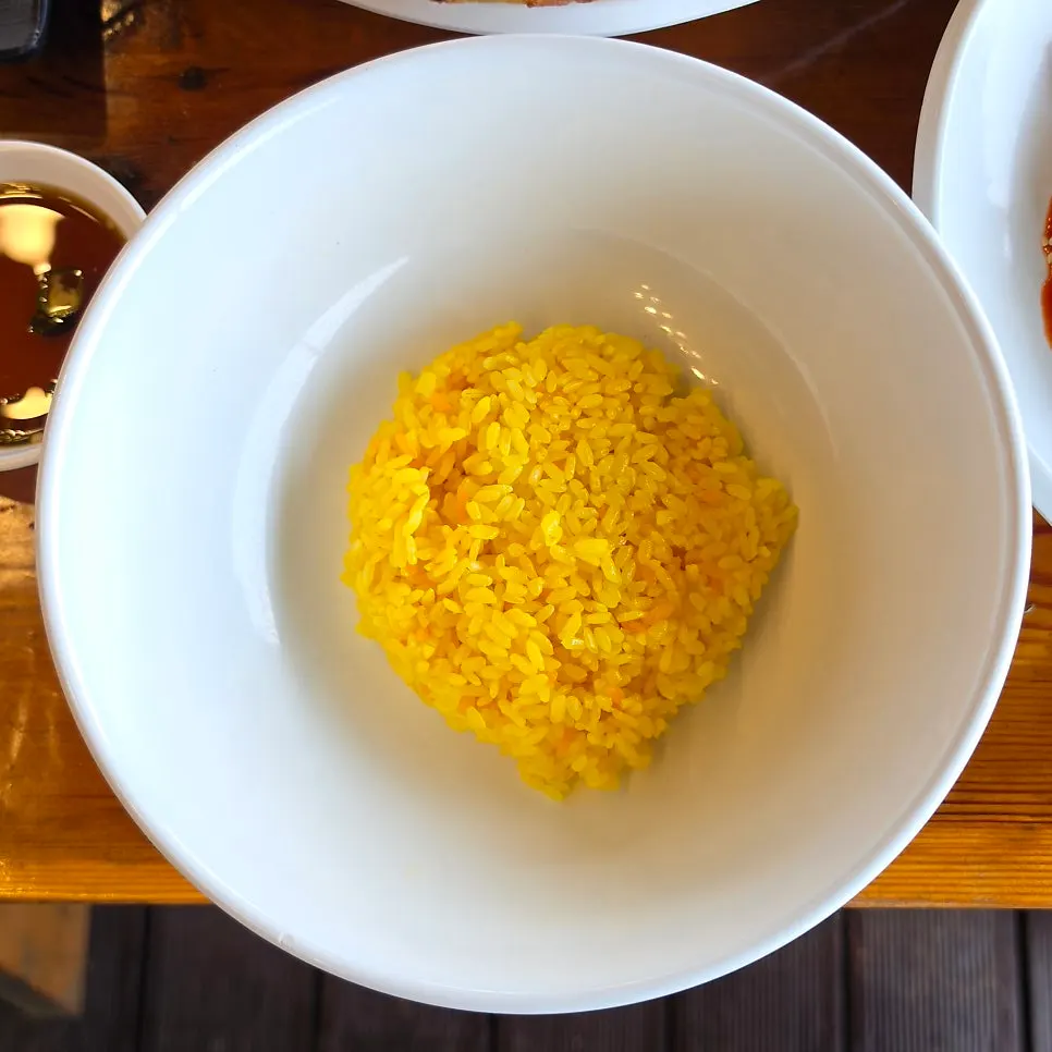 Yellow turmeric rice served in a large bowl