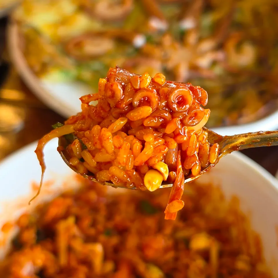 Turmeric rice mixed with bean sprouts and octopus stir-fry