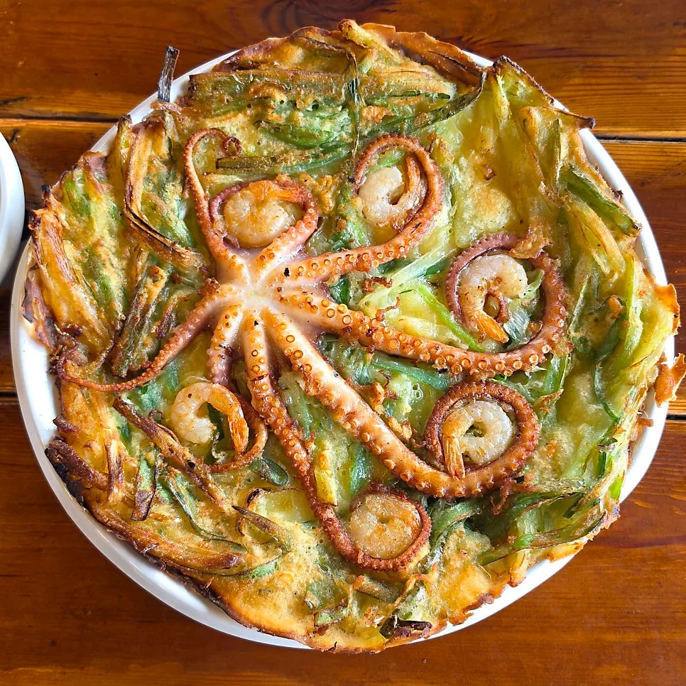 Seafood pancake topped with a whole octopus