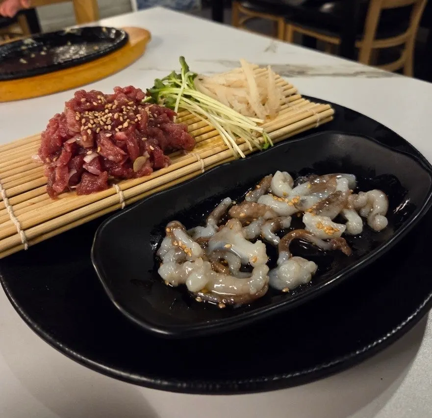 Live octopus tartare and beef tartare, octopus still moving