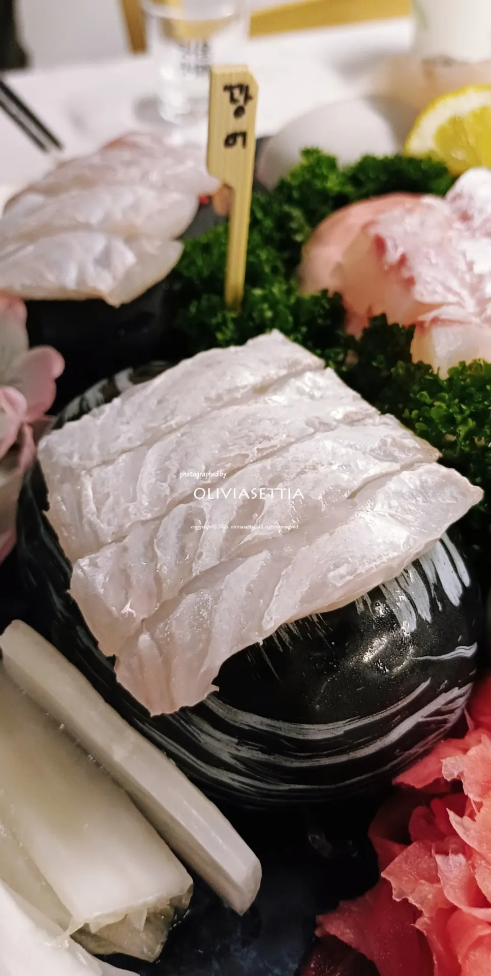 A thick piece of aged flounder sashimi