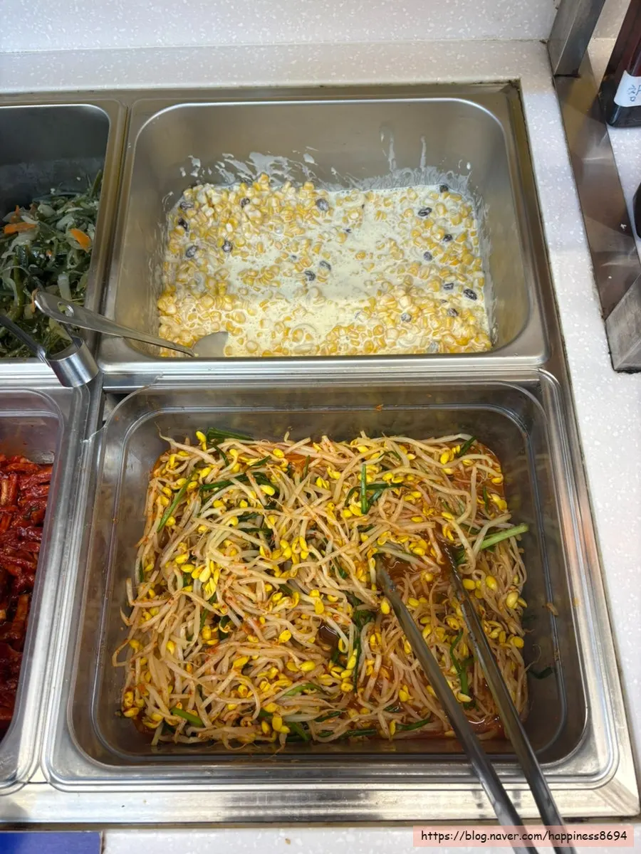 Scooping side dishes from the self-serve bar