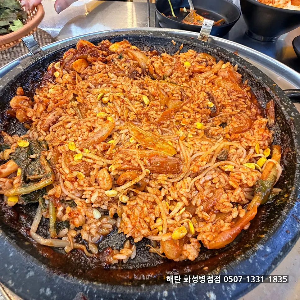 Fried rice spread across the whole hot plate to cook further