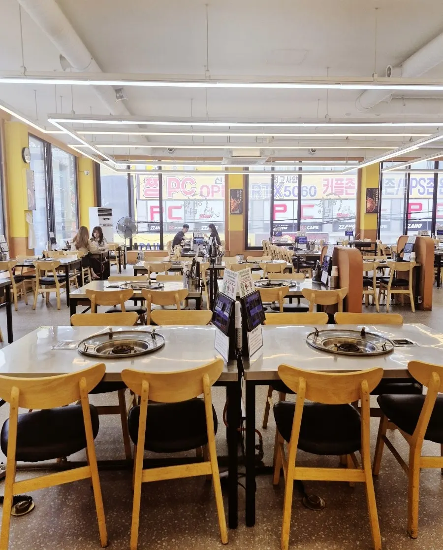Spacious restaurant interior with tables set well apart