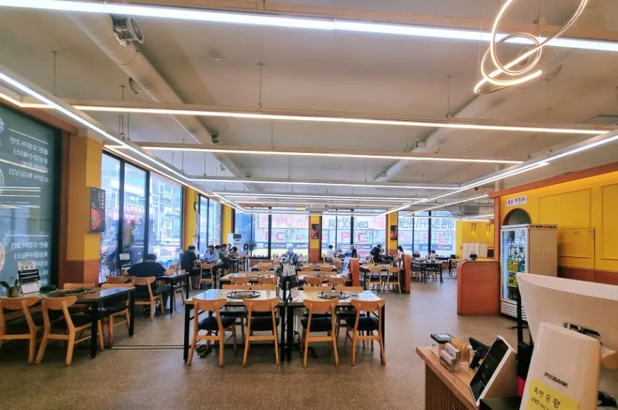 Spacious dining hall at Haetan Hwaseong Byeongjeom lit by floor-to-ceiling windows