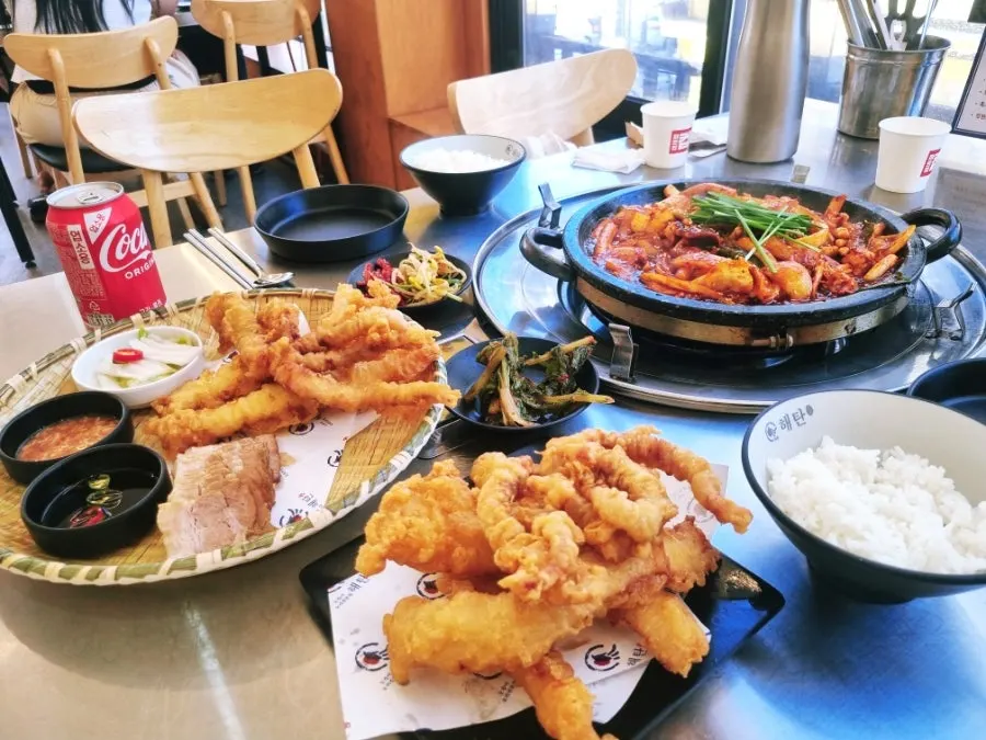 Full table spread of the set for two with rice and side dishes