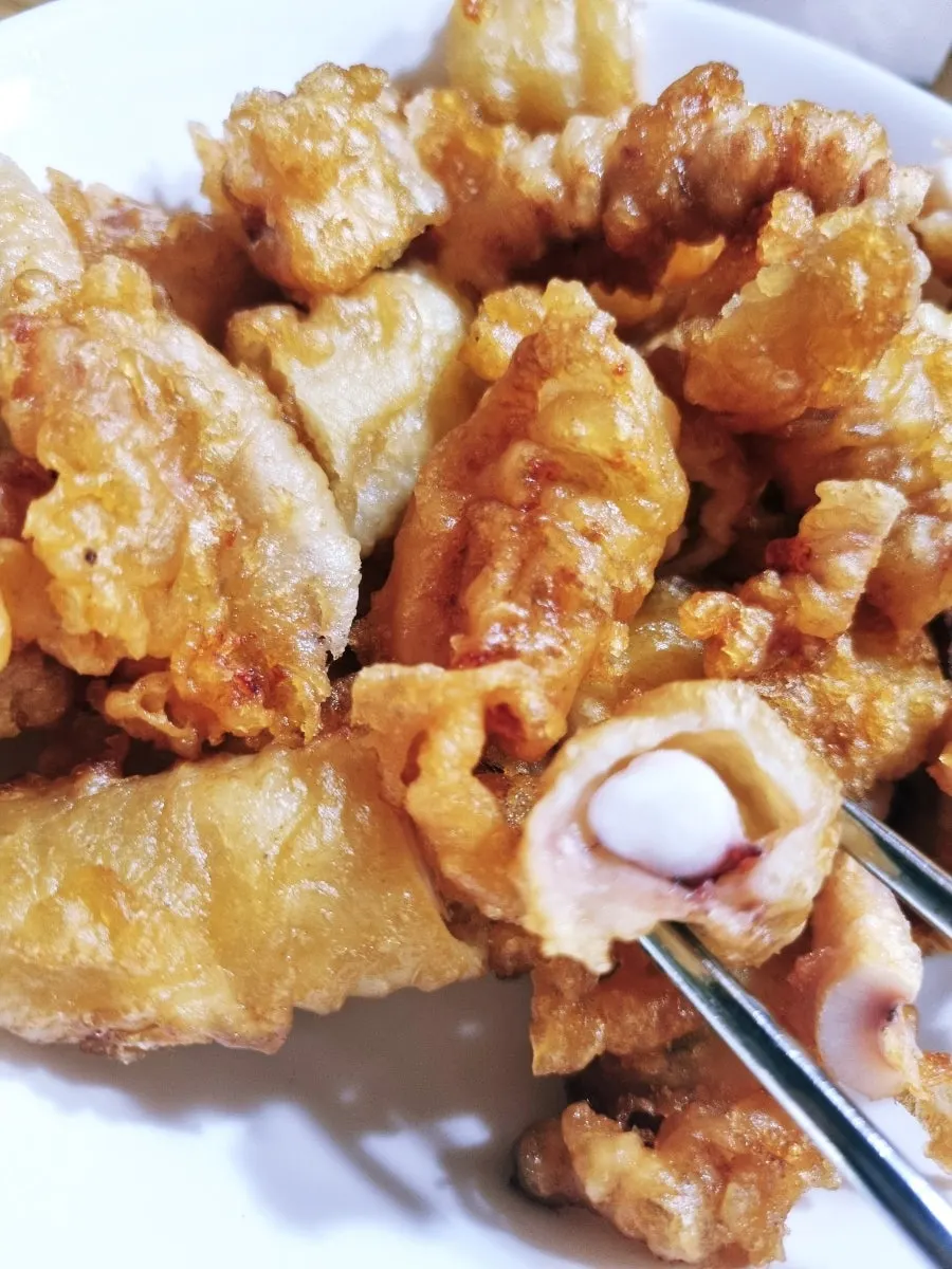 Close-up of takeout squid fritters showing crispy texture