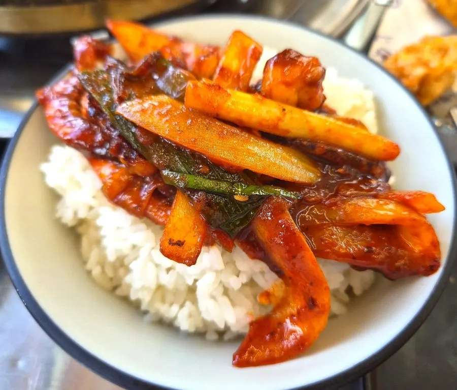 Squid stir-fry mixed into a bowl of rice
