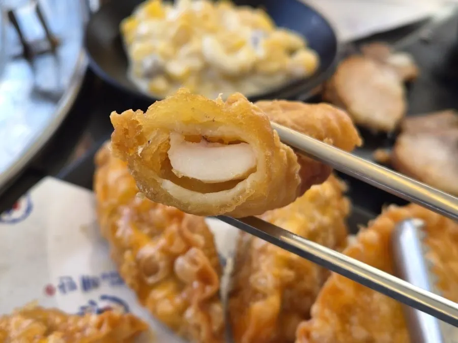 Close-up of a piece of fried squid being picked up