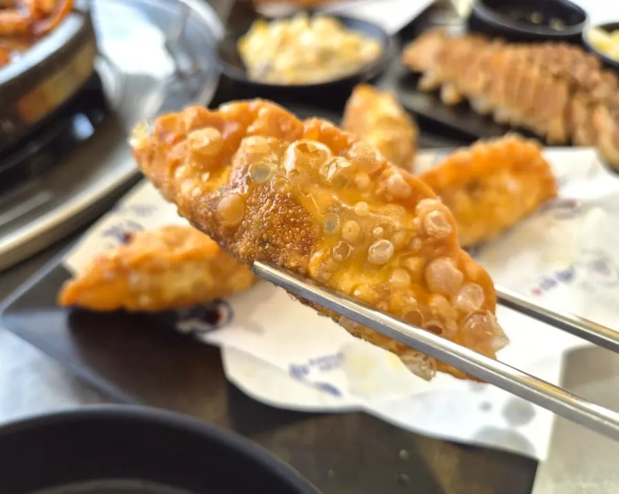Cross-section of fried squid mandu showing the filling