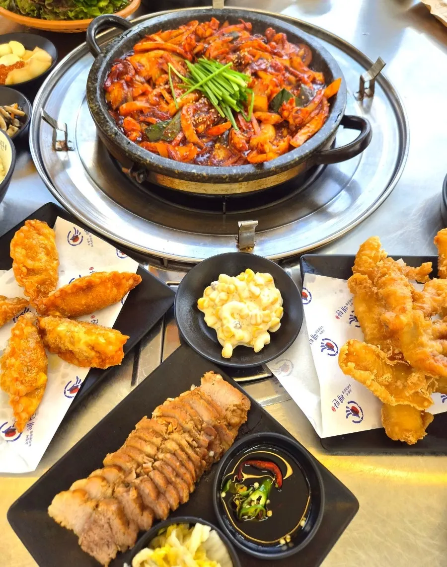 Full table spread of four squid feast dishes