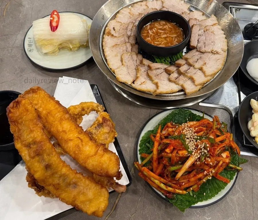 A table set with squid dishes and boiled pork